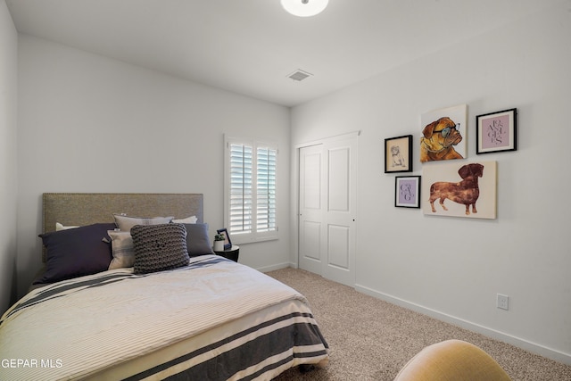 carpeted bedroom with visible vents and baseboards