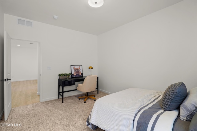 carpeted bedroom featuring baseboards and visible vents