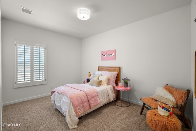 carpeted bedroom with baseboards and visible vents