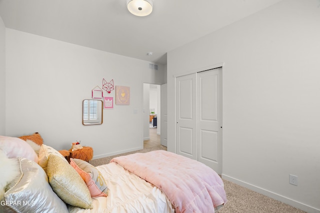 bedroom with light carpet, a closet, visible vents, and baseboards
