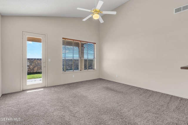 carpeted empty room with a wealth of natural light, ceiling fan, and vaulted ceiling