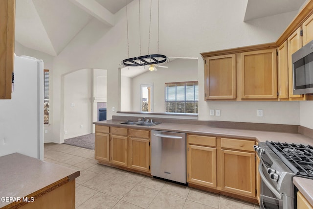 kitchen featuring stainless steel appliances, sink, beam ceiling, light tile patterned floors, and high vaulted ceiling