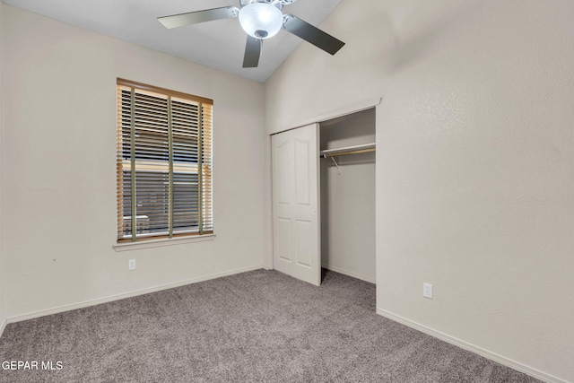 unfurnished bedroom featuring ceiling fan, light colored carpet, a closet, and vaulted ceiling