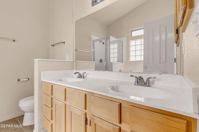 bathroom with a shower with door, vanity, vaulted ceiling, tile patterned flooring, and toilet