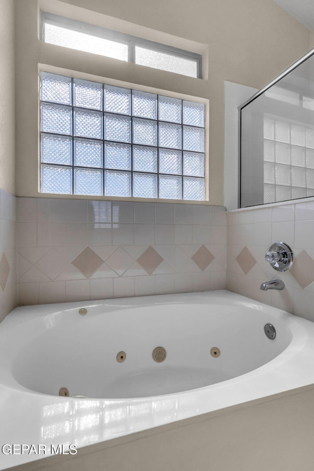 bathroom with plenty of natural light and a washtub