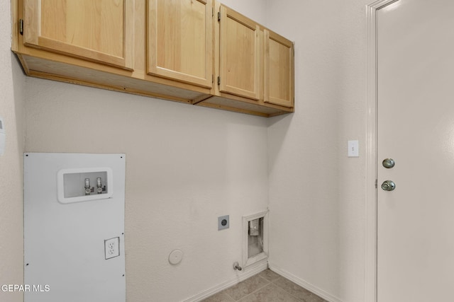 clothes washing area with cabinets, washer hookup, light tile patterned floors, electric dryer hookup, and hookup for a gas dryer