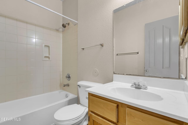 full bathroom with vanity, toilet, and tiled shower / bath combo