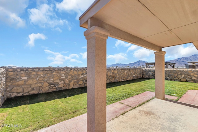 view of yard featuring a patio and a mountain view