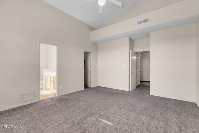 carpeted spare room featuring high vaulted ceiling and ceiling fan