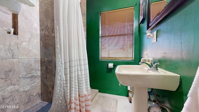 bathroom featuring tile patterned flooring and walk in shower