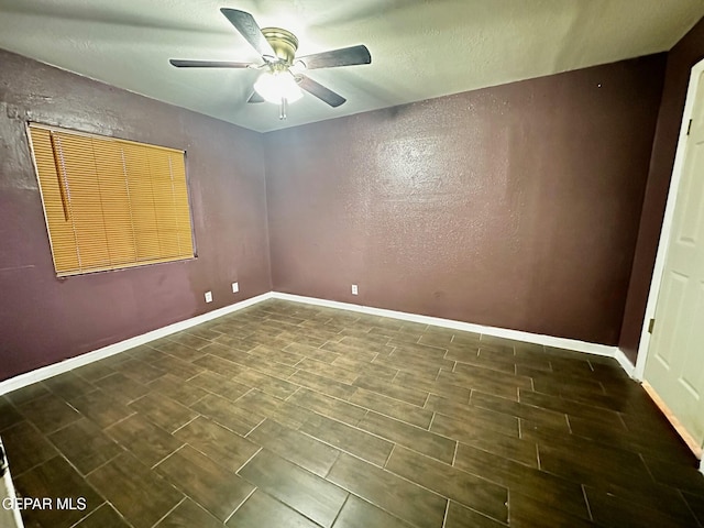 unfurnished room with dark hardwood / wood-style flooring and ceiling fan