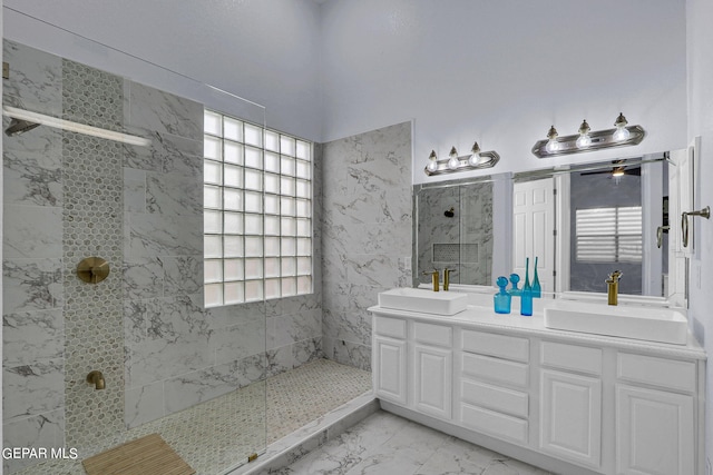 bathroom with vanity and tiled shower