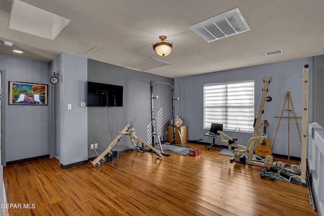 workout area featuring hardwood / wood-style floors