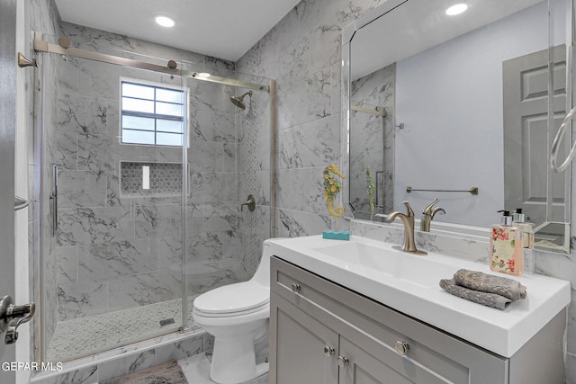 bathroom with an enclosed shower, vanity, and toilet