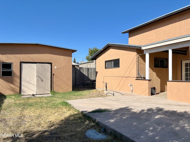 view of yard with a patio area and a storage shed