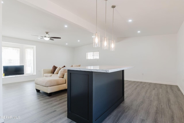 kitchen with hardwood / wood-style floors, a center island, hanging light fixtures, and ceiling fan