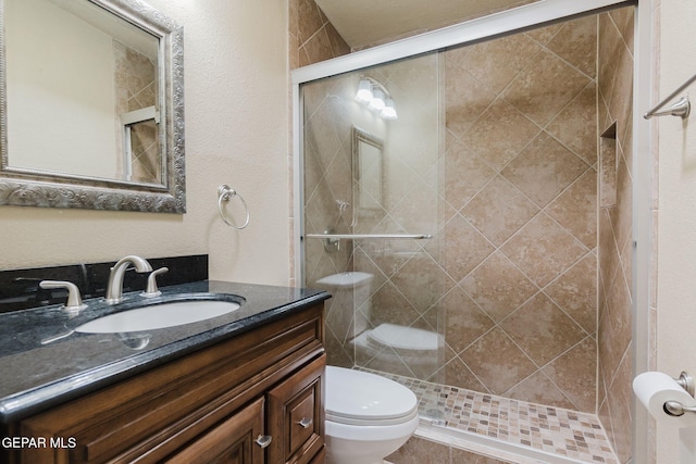 bathroom with vanity, toilet, and an enclosed shower