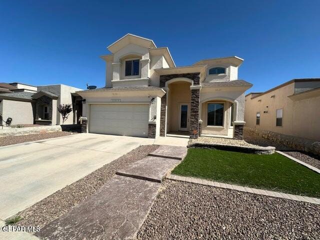 12419 Winners Cir, El Paso, TX 79928 - view of front facade with a garage, stucco siding, driveway, and stone siding