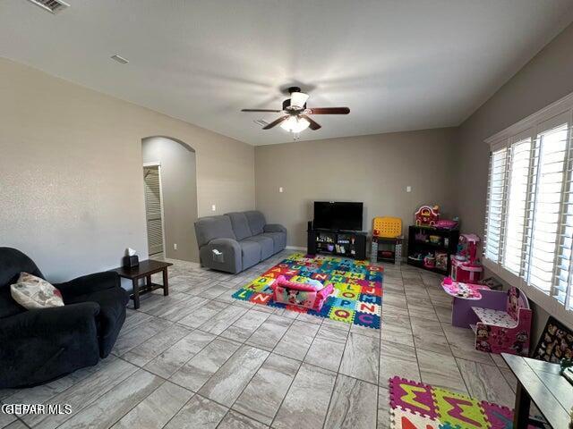 12419 Winners Cir, El Paso, TX 79928 - playroom with a ceiling fan, arched walkways, and healthy amount of natural light
