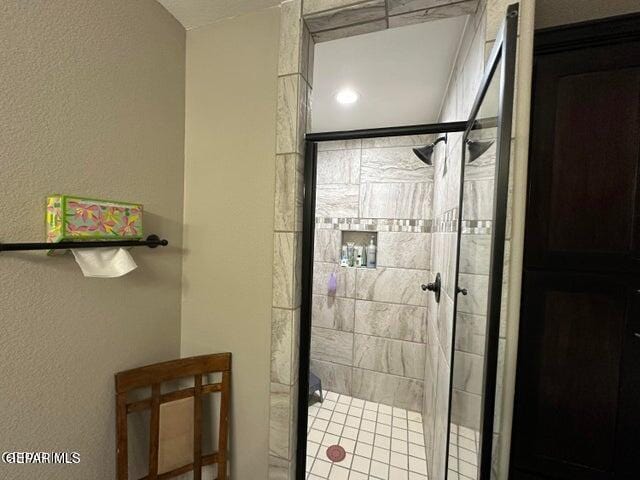 bathroom featuring a shower with shower door