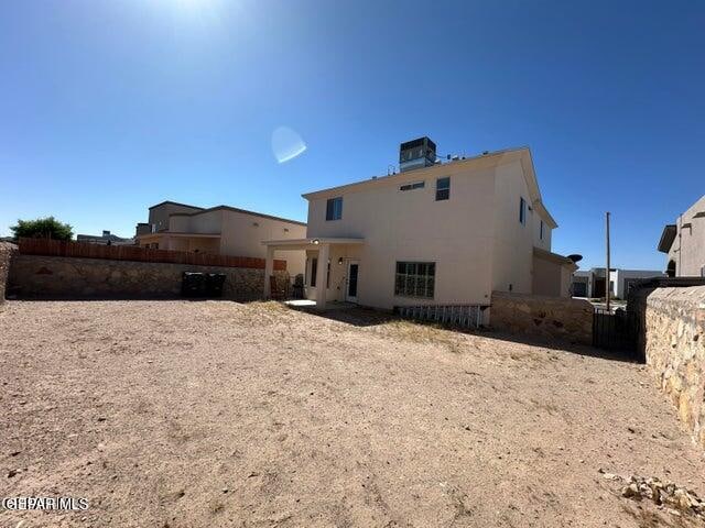 back of house featuring central air condition unit