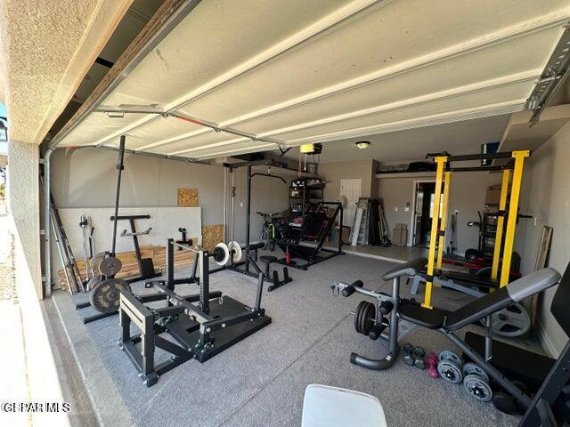 12419 Winners Cir, El Paso, TX 79928 - workout room featuring a garage