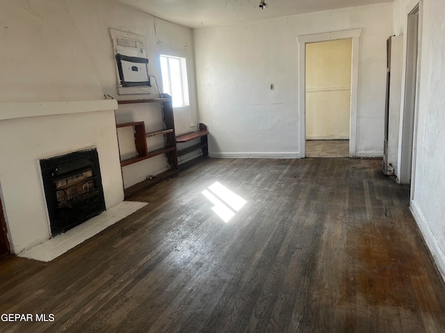 unfurnished living room with dark wood-type flooring