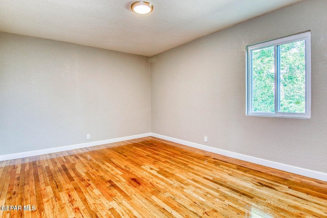 spare room featuring light hardwood / wood-style floors