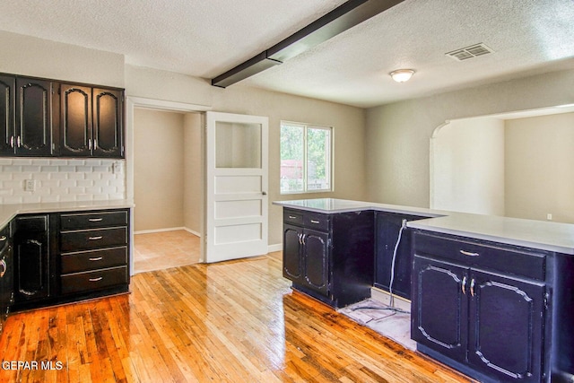 washroom featuring a textured ceiling and light wood-type flooring