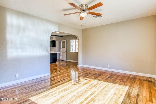 unfurnished room with hardwood / wood-style floors and ceiling fan