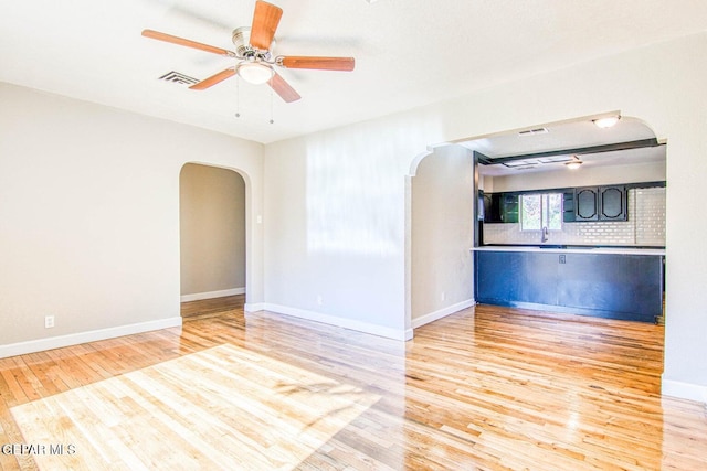 empty room featuring light hardwood / wood-style flooring and ceiling fan