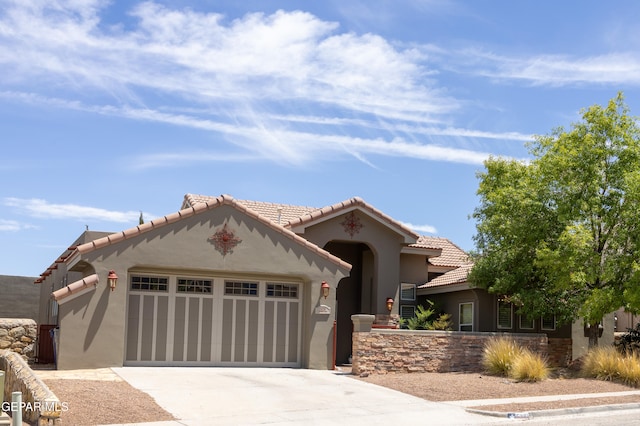 mediterranean / spanish-style house with a garage