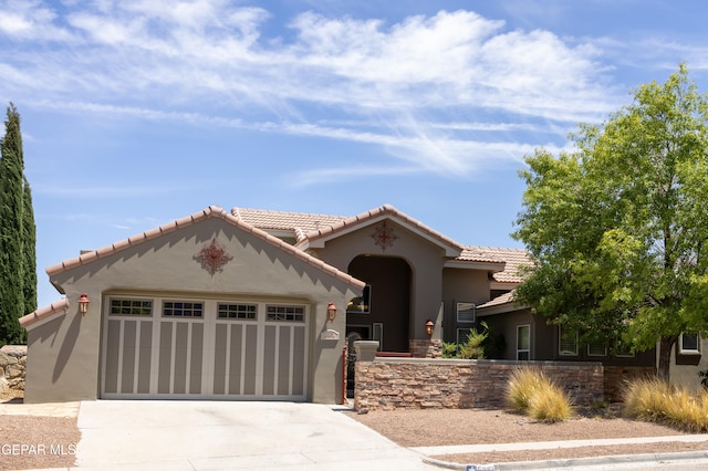 mediterranean / spanish-style home featuring a garage