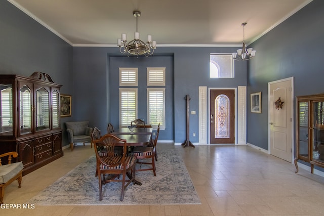 dining space featuring crown molding, a notable chandelier, and a towering ceiling