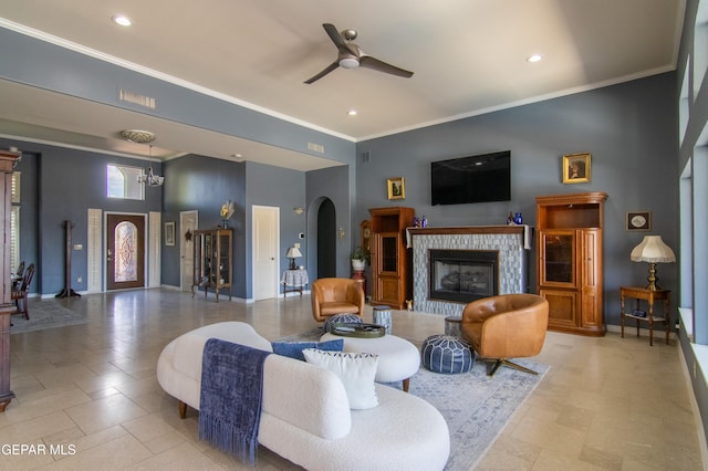 tiled living room featuring ornamental molding and ceiling fan