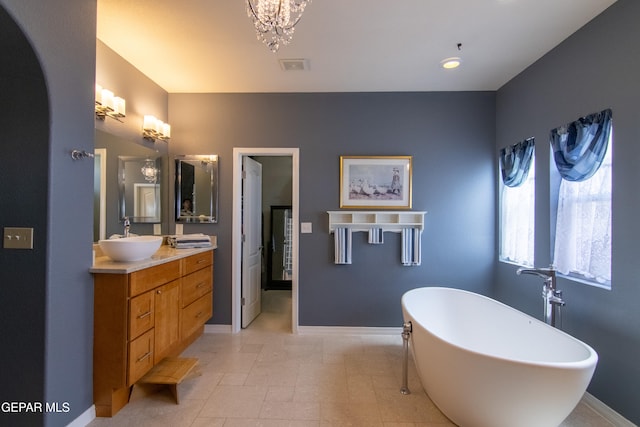 bathroom featuring vanity and a washtub