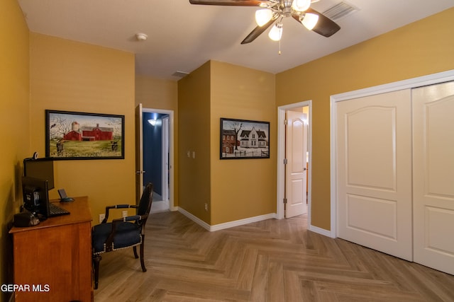 office space with light parquet floors and ceiling fan