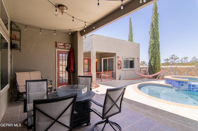 view of patio / terrace featuring an in ground hot tub