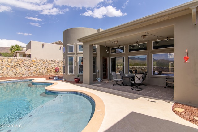 view of pool featuring a patio and ceiling fan