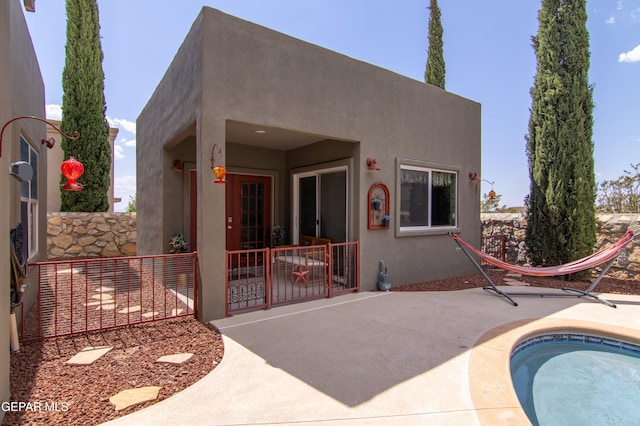 back of property with a patio