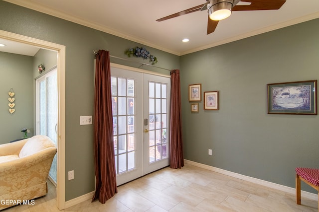 entryway with french doors, ornamental molding, and ceiling fan