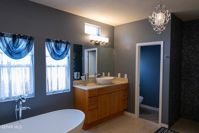 bathroom featuring toilet, a bathing tub, vanity, and tile patterned flooring