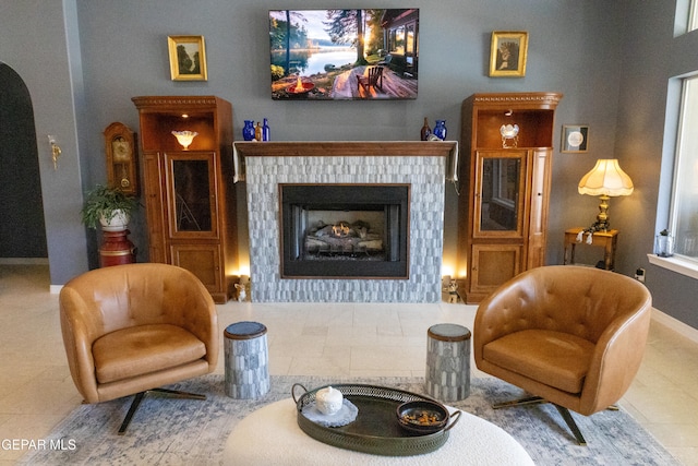 sitting room with tile patterned floors and a fireplace