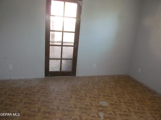 unfurnished room with dark parquet flooring