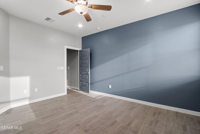 spare room featuring hardwood / wood-style flooring and ceiling fan