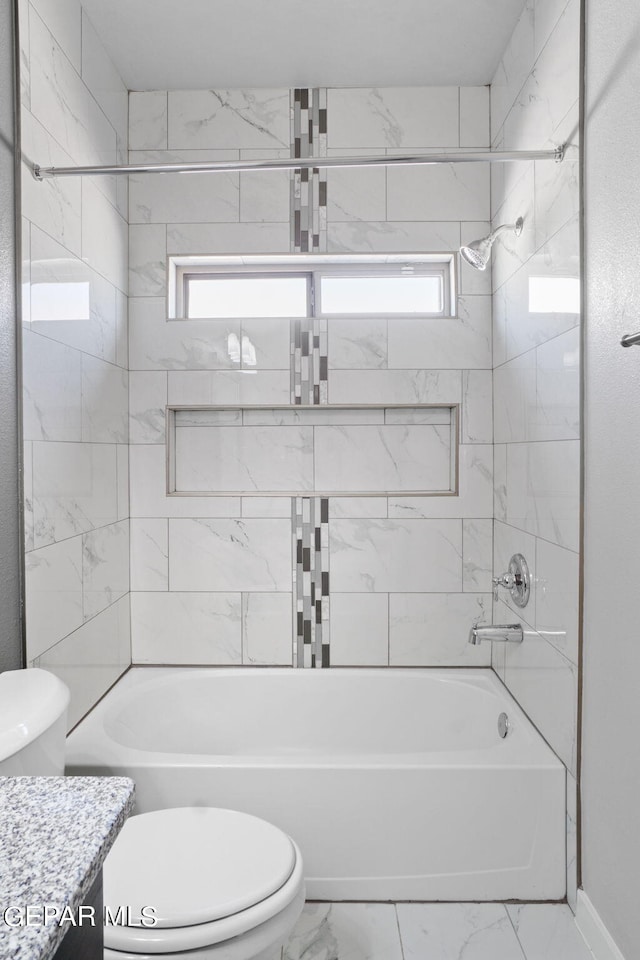 full bathroom featuring toilet, tiled shower / bath combo, and vanity