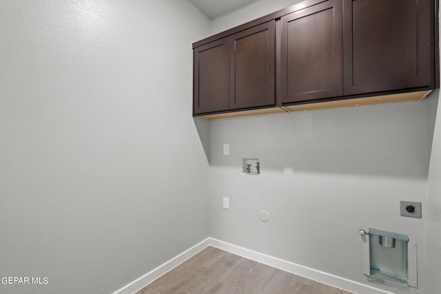 laundry area featuring cabinets, light hardwood / wood-style flooring, hookup for a washing machine, hookup for a gas dryer, and hookup for an electric dryer