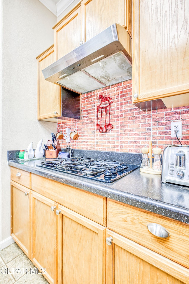 kitchen featuring black gas stovetop, light brown cabinets, and ventilation hood