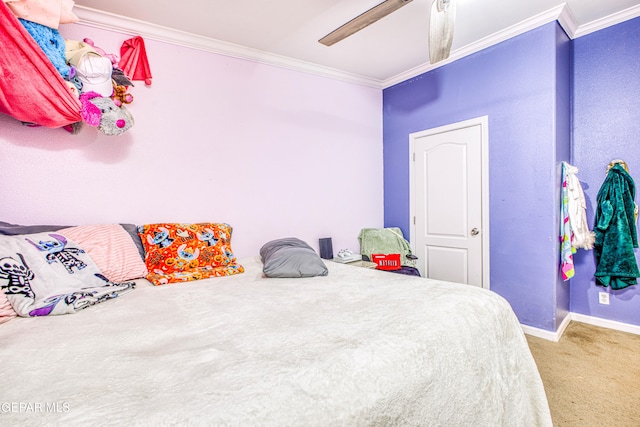 carpeted bedroom featuring ceiling fan and ornamental molding