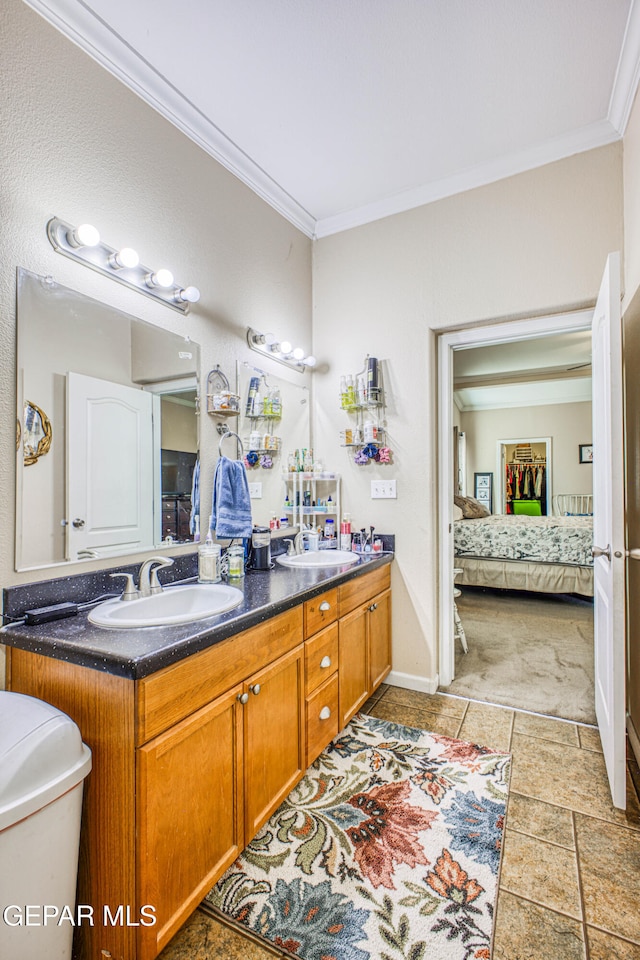 bathroom featuring vanity, crown molding, and toilet